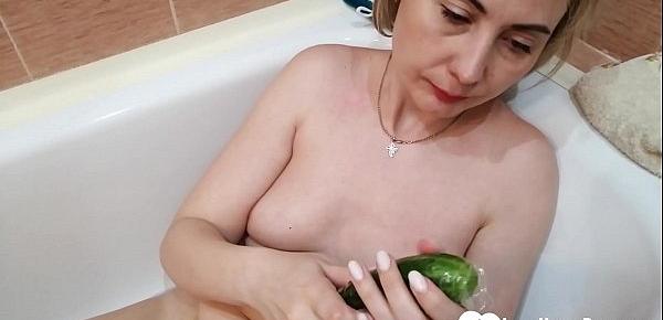  Hot mom uses a cucumber in a bathtub